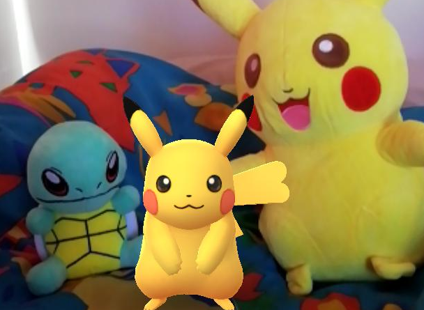 Here's one of my earliest catches, a Pikachu I got from some of my first field research, alongside some Pokemon I won in a claw machine. Yes, my duvet cover has dinosaurs on it.